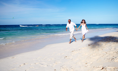 Wall Mural - Couple running on the beach