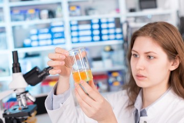 girl in the laboratory testing of food quality egg. Check the co