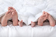 © didesign - Couple with baby showing foot under the blanket