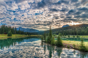 Wall Mural - Amazing Clouds and Trees Reflected in Lake