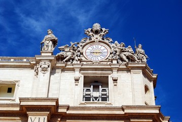 Wall Mural - Sculptures and clock on the facade of Vatican city works