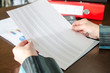 © thodonal - Female accountant checking financial documents