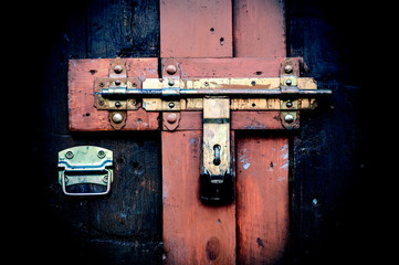 Retro vintage style picture of wooden door with lock.