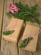 string and brown paper parcels with conifer decoration and check