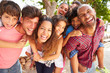 © Monkey Business - Group Of Parents Giving Children Piggyback Ride Outdoors