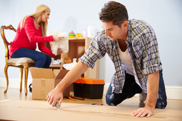 Wall Mural - Couple Preparing To Assemble Flat Pack Furniture In Nursery