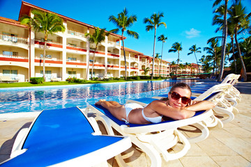 Wall Mural - Woman relaxing near the pool.