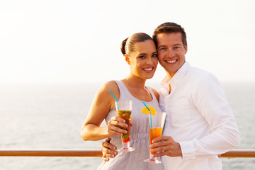 Wall Mural - couple holding cocktails on cruise