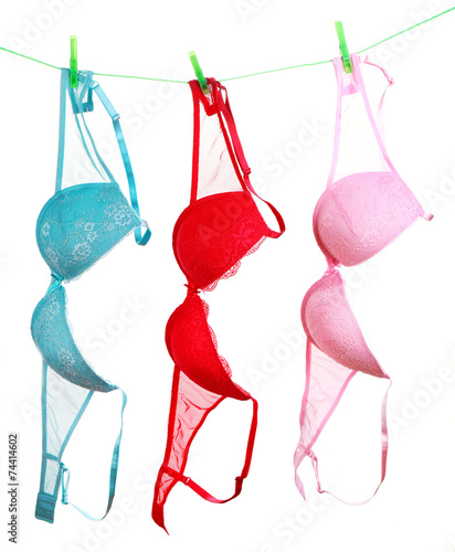 Woman bra hanging on rope isolated on white background Stock Photo