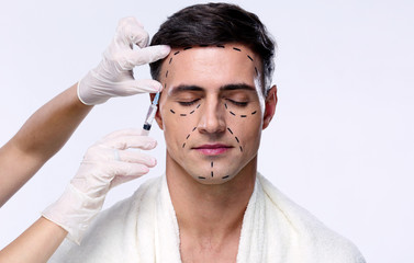 Poster - Man with closed eyes at plastic surgery with syringe in his face