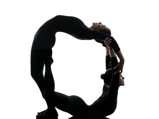 two women contortionist  exercising gymnastic yoga silhouette