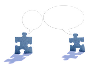 Two Jigsaw Puzzle Pieces on White with Talking Bubble