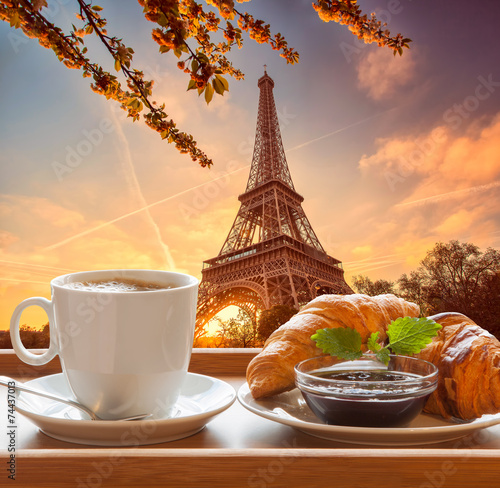 Fototapeta na wymiar Coffee with croissants against Eiffel Tower in Paris, France