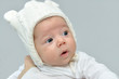 © zdravinjo - Cute newborn baby girl with white knitted woolen winter cap