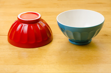 two colorful bowls, one upside down