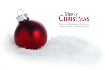 Wall Mural - red christmas ball in snow isolated on white background, sample