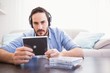 © WavebreakMediaMicro - Man holding cd while listening to music