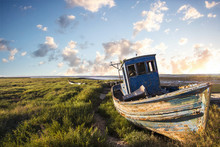 View Of An Old Abandoned Fishing Boat On The Marshlands.