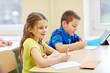 © Syda Productions - group of school kids writing test in classroom