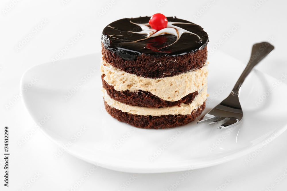 Yummy chocolate cupcake on white plate, close-up