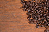Fototapeta Kuchnia - Coffee beans on wooden background.