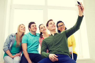 Sticker - five smiling students taking picture with camera