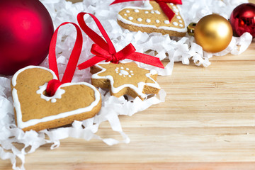 Gingerbread and Christmas balls laying on a wooden table