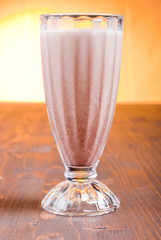 Canvas Print - chocolate banana cocktail on brown board at sunset