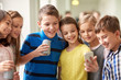 © Syda Productions - group of school kids with smartphone and soda cans