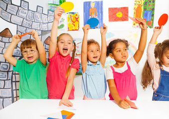 Happy group of kids with cardboard shapes