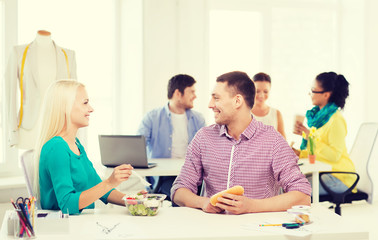 Poster - smiling fashion designers having lunch at office