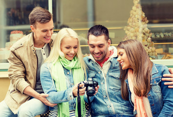 Canvas Print - group of smiling friends with digital photocamera