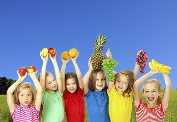 Wall Mural - Happy children with fruits outdoors