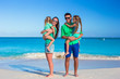 © travnikovstudio - Family of four with two kids during beach vacation