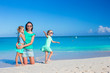 © travnikovstudio - Little cute girls and young mother during tropical beach