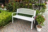 Fototapeta Tulipany - White iron chair on pavement