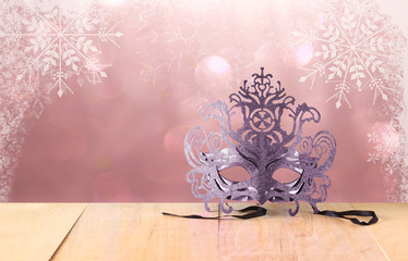 Wall Mural - Mysterious Venetian masquerade mask on wooden table and glitter 