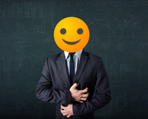 businessman wears yellow smiley face