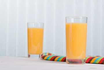 Sticker - Orange fresh juice beside delicious ripe oranges on the table