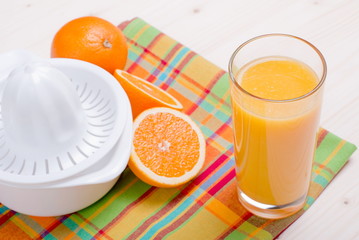 Sticker - orange juice beside delicious ripe oranges on the table