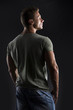 © theartofphoto - Handsome muscular fit young man's back on dark background