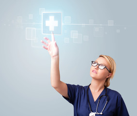 Wall Mural - Young nurse pressing modern medical type of buttons