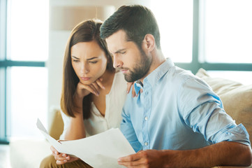 Canvas Print - Examining documents together.