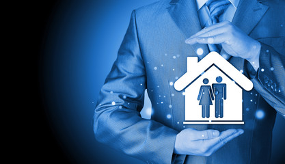 Wall Mural - businessman protecting family in home with hands