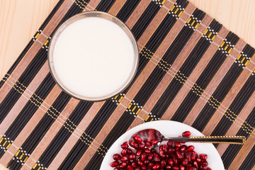 Wall Mural - Opened pomegranate seeds and juice. Top view.