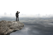 Man Looking On Cliff With Gray Cloudy Sky Cityscape  Background