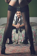 Elegant man portrait with sensual woman legs