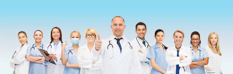 Wall Mural - group of smiling doctors with showing thumbs up