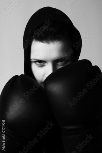 Poster closeup portrait of girl with black boxing gloves