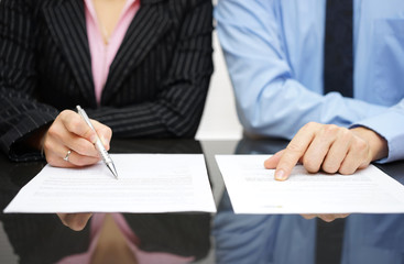 businessman and businesswoman are inspecting contract